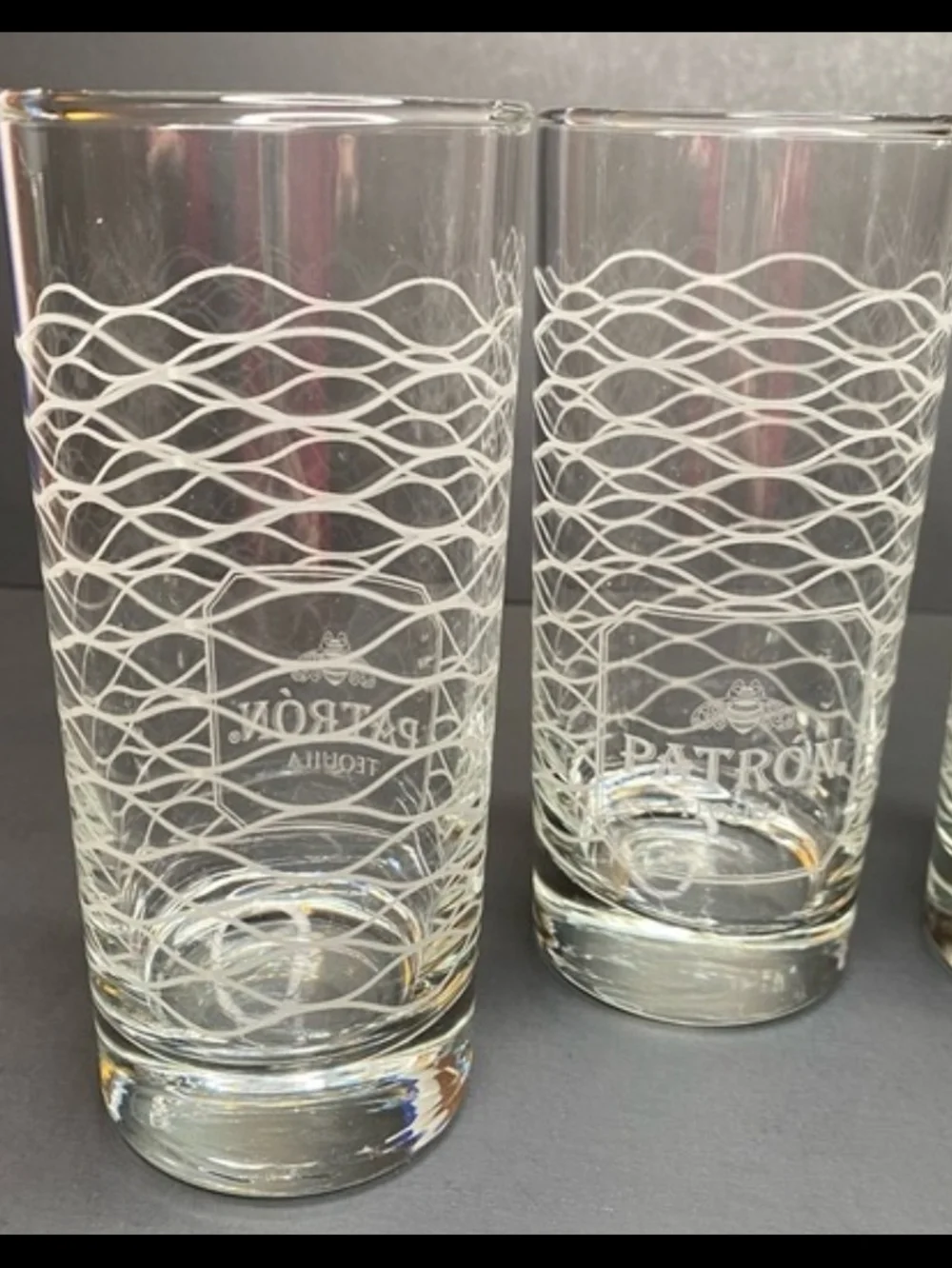 Patrón Tequila highball glass with a frosted wave pattern and the signature bee